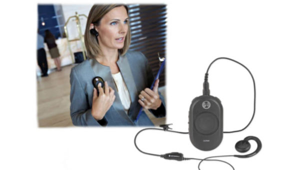 Hotel manager using the Motorola CLP446 walkie talkie to comunicate with her staff.