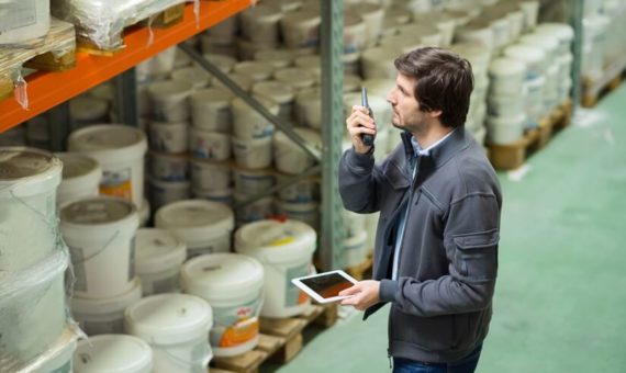 Warehouse worker using a walkie talkie