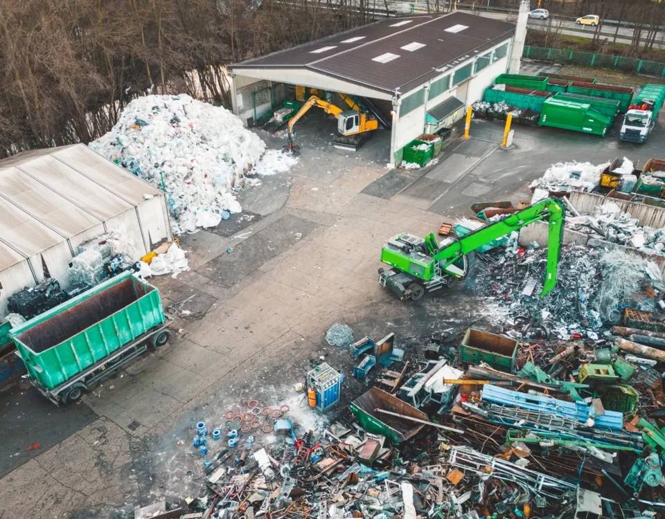 Aerial view of a recycling centre with waste containers, collection vehicles and machinery operating across the site.