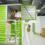 Customer accessing a storage unit inside a self storage facility with individual storage units and loading areas.
