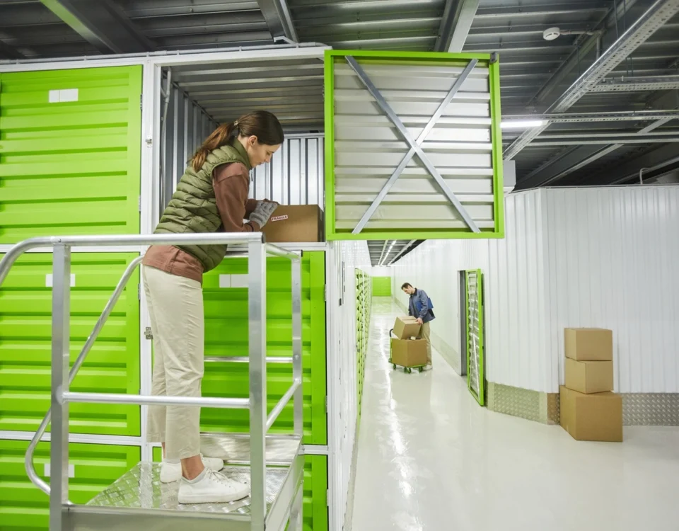 Customer accessing a storage unit inside a self storage facility with individual storage units and loading areas.